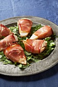 Pears wrapped in Prosciutto on a bed of rocket