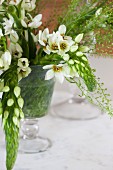 Glass vase of white flowers on table
