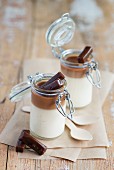 Panna cotta with a layer of caramel served in small flip-top jars