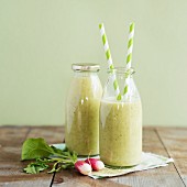 Cold soup with courgettes and goat's cream cheese in bottles with straws