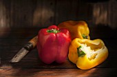Red and yellow peppers, whole and halved