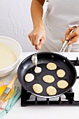 Blini batter being added to a pan