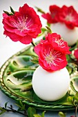 Red peach blossom in miniature vases made from eggshells