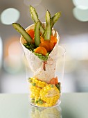 A tortilla wrap filled with vegetables and sweetcorn