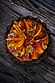Fruit tart with berries and passion fruit (seen from above)