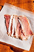 Rashers of bacon on a piece of greaseproof paper