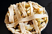 An unbaked apple pie with a lattice lid