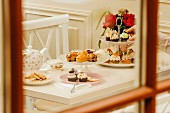 A table laid for tea with scones, cookies and cupcakes