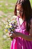 Girl with posy of wild flowers