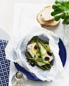 Steamed fish with asparagus, olives and lemons