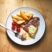 Beef steak with Bearnaise sauce, chips and cherry tomatoes