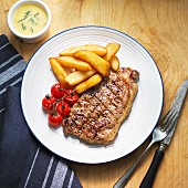 Beef steak with Bearnaise sauce, chips and cherry tomatoes