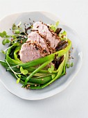 Roasted pork marinated in tea with sesame seeds and spring onions