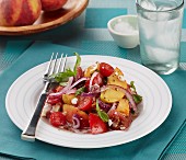 Tomato and peach salad with feta cheese and red onions