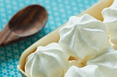 White meringues in a wooden dish