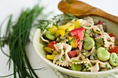 Pasta salad with broad beans, tomatoes, peppers and fresh garden herbs