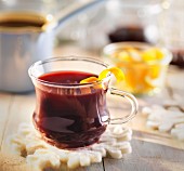 Mulled wine with lemon zest in a glass cup