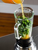 A green kale smoothie being made