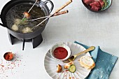 Fondue with vegetables and meat