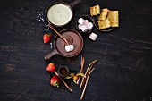 Chocolate fondue with waffles, marshmallows and fruit