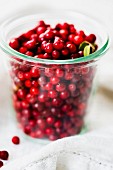 A glass of fresh cranberries