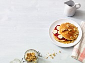 Almond pancakes with jam, bananas, maple syrup and walnuts