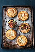 Goat's cheese tartlets on a baking tray