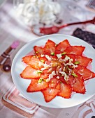 Strawberry carpaccio with dates, pistachios and nougat