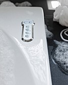 Detail of a bubble jet Bath, buttons on a stainless steel cover plates for various settings