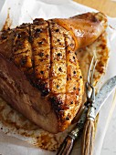 Apple glazed ham with a carving knife and fork