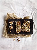 Homemade chocolate bars with pretzel sticks and pistachios