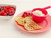 Waffles with red berry jelly and whipped cream