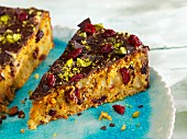 Carrot and chocolate cake with cranberries and pistachio nuts