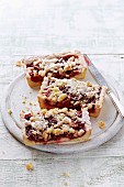 Slices of plum cake with coconut crumbles