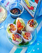 Rice paper rolls filled with duck breast, vegetables and grapefruit
