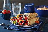 Pancakes with berries and icing sugar