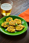 Tostones (deep-fried plantains) from Cuba with a beer