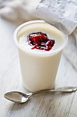 A cup of natural yogurt with jam