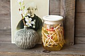 Pickled bean sprouts in jars in front of a portrait