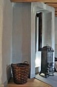 Wicker basket and antique stove in niche