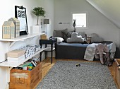 Vintage-style attic room with comfortable bed, pale grey leather rug, crate of books and soft toys