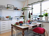 Christmas atmosphere in modern kitchen with Advent wreath above set table