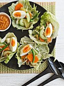 Lettuce leaves filled with vegetables and hard-boiled eggs (Indonesia)