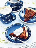 Two slices of damson cake with whipped cream