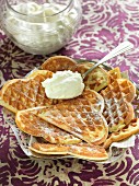 Crispy waffles with icing sugar and whipped cream