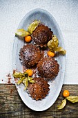 Mini chocolate cakes with physalis and icing sugar