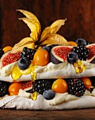 Pavlova with fruit, berries and honey