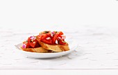 Bruschetta topped with tomatoes and onions