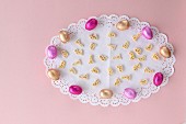 Chocolate Easter eggs and rabbit-shaped pasta on a white doily