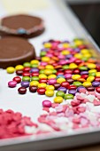Colourful chocolate beans and sugar hearts for decorating